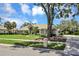Stunning single-story home with manicured lawn and mature landscaping creating a welcoming curb appeal at 8623 Summerville Pl, Orlando, FL 32819