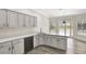 Updated kitchen featuring white cabinets, quartz counters, stainless appliances, and access to the pool at 8623 Summerville Pl, Orlando, FL 32819