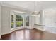 Bright living room offering a bay window, tile flooring, a decorative column and neutral paint at 8623 Summerville Pl, Orlando, FL 32819