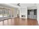 Open living room features hardwood floors, a modern fireplace, a ceiling fan, and glass patio doors at 8623 Summerville Pl, Orlando, FL 32819