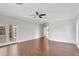 Open living room features hardwood floors, ceiling fan, and glass patio doors at 8623 Summerville Pl, Orlando, FL 32819