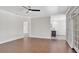 Spacious living room with wood floors, neutral paint and views into the kitchenette at 8623 Summerville Pl, Orlando, FL 32819