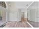 Open-concept living area featuring wood-look floors, high ceilings, and french doors leading to the outdoors at 8623 Summerville Pl, Orlando, FL 32819