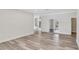 Spacious living room featuring wood-look flooring, neutral paint, and arched doorways at 8623 Summerville Pl, Orlando, FL 32819