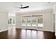 Bright living room with wood floors, crown moulding, and sliding glass doors to the pool at 8623 Summerville Pl, Orlando, FL 32819