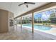 Covered patio area with tile flooring leading to a pool and spa with screened enclosure at 8623 Summerville Pl, Orlando, FL 32819