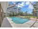 Backyard pool and spa with a large screened enclosure and surrounding mature landscaping at 8623 Summerville Pl, Orlando, FL 32819