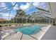 Backyard pool and spa with a large screened enclosure and manicured landscaping at 8623 Summerville Pl, Orlando, FL 32819