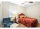 Cozy bedroom with ceiling fan, comfortable bed, and warm ambiance at 1028 Salamanca Pl, Davenport, FL 33837