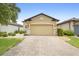 Charming single-story home with manicured lawn and a two-car garage, enhancing curb appeal at 1028 Salamanca Pl, Davenport, FL 33837