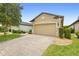 Beautiful home with a brick paver driveway and an attached two-car garage at 1028 Salamanca Pl, Davenport, FL 33837