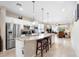 Open kitchen with stainless steel appliances, granite countertops, and a large center island with seating at 1028 Salamanca Pl, Davenport, FL 33837
