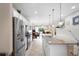 Open kitchen and dining space with a large island and stainless steel appliances at 1028 Salamanca Pl, Davenport, FL 33837