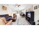 Inviting living room open to kitchen, with tile floors, cozy seating, and large television console at 1028 Salamanca Pl, Davenport, FL 33837