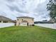 Wide shot of the large backyard with a white fence and view of the neighboring houses at 10549 Cypress Trail Dr, Orlando, FL 32825