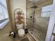 Stylish bathroom with a glass-enclosed shower, mosaic tile accents, and shelving for storage at 10549 Cypress Trail Dr, Orlando, FL 32825