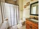 Simple bathroom featuring tile floors, shower with curtain, and a single sink vanity at 10549 Cypress Trail Dr, Orlando, FL 32825