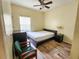 Simple bedroom with a bed, nightstand, and desk, offering a cozy and functional space at 10549 Cypress Trail Dr, Orlando, FL 32825