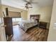 Comfortable bedroom with a ceiling fan, natural light, and wood-look floors at 10549 Cypress Trail Dr, Orlando, FL 32825