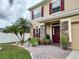Charming two-story home with landscaped yard and inviting entryway at 10549 Cypress Trail Dr, Orlando, FL 32825