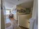 Hallway leading to a cozy living room adorned with framed pictures on the wall and natural lighting at 10549 Cypress Trail Dr, Orlando, FL 32825