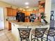 Well-equipped kitchen featuring granite countertops, wood cabinetry, and modern appliances at 10549 Cypress Trail Dr, Orlando, FL 32825