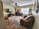 Cozy living room with a ceiling fan, comfortable seating, and a large television for entertainment at 10549 Cypress Trail Dr, Orlando, FL 32825