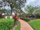 Community playground featuring a slide, swings, and plenty of shade at 10549 Cypress Trail Dr, Orlando, FL 32825