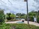 Community pool area with hot tub, lounge chairs, lush tropical landscaping at 10549 Cypress Trail Dr, Orlando, FL 32825
