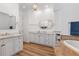 Elegant bathroom featuring dual vanities, soaking tub, and linen storage at 11018 Lake Butler Blvd, Windermere, FL 34786