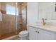 Bathroom featuring tiled shower and a modern vanity with marble countertops at 11018 Lake Butler Blvd, Windermere, FL 34786