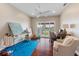 Sunlit bedroom with ceiling fan, desk, art easel, comfortable chair, and sliding doors to balcony at 11018 Lake Butler Blvd, Windermere, FL 34786