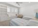 Bright bedroom with built-in shelving, window seat, and twin beds with blue and white striped linens at 11018 Lake Butler Blvd, Windermere, FL 34786