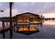 Charming boat dock on a tranquil lake at dusk, providing easy water access for boating and recreation at 11018 Lake Butler Blvd, Windermere, FL 34786