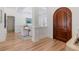 Bright dining area featuring wood floors, decorative molding, and a grand arched doorway at 11018 Lake Butler Blvd, Windermere, FL 34786