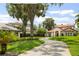 Charming home with a tile roof, lush landscaping, and a winding driveway at 11018 Lake Butler Blvd, Windermere, FL 34786