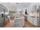 Spacious kitchen features a central island, stainless appliances, and adjoining living area with lake views at 11018 Lake Butler Blvd, Windermere, FL 34786