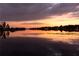 Scenic lake view at sunset with a reflection of the colorful sky on the calm water at 11018 Lake Butler Blvd, Windermere, FL 34786