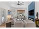 Bright living room with modern fireplace, TV, and comfortable seating facing the window at 11018 Lake Butler Blvd, Windermere, FL 34786