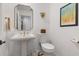 Stylish powder room with a pedestal sink, decorative mirror, and modern fixtures at 11018 Lake Butler Blvd, Windermere, FL 34786