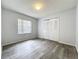 Bedroom with window providing natural light, wood-look flooring, and closet at 1113 Woodman Way, Orlando, FL 32818