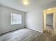 This bedroom features light walls, wood-look flooring, and a window offering natural light at 1113 Woodman Way, Orlando, FL 32818