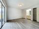 This spacious bedroom features sliding glass doors, wood-look flooring, and ample closet space at 1113 Woodman Way, Orlando, FL 32818