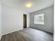 Bright bedroom showcasing wood-look floors, a window for natural light, and a closet at 1113 Woodman Way, Orlando, FL 32818