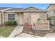 Charming front exterior of a stone-clad home with a well-maintained landscaped entrance and blue sky at 1113 Woodman Way, Orlando, FL 32818