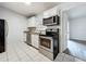 The kitchen has stainless steel appliances and white cabinets at 1113 Woodman Way, Orlando, FL 32818