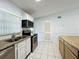 Bright kitchen featuring stainless steel appliances, granite countertops, and white cabinets at 1113 Woodman Way, Orlando, FL 32818