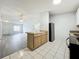 The kitchen island overlooks the living room and has a stainless steel fridge at 1113 Woodman Way, Orlando, FL 32818