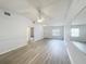 The airy living room offers fresh paint, new flooring, ceiling fan and easy access to all other parts of the house at 1113 Woodman Way, Orlando, FL 32818