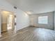 A spacious living room with new flooring, fresh paint, and lots of natural light for a bright and airy feel at 1113 Woodman Way, Orlando, FL 32818